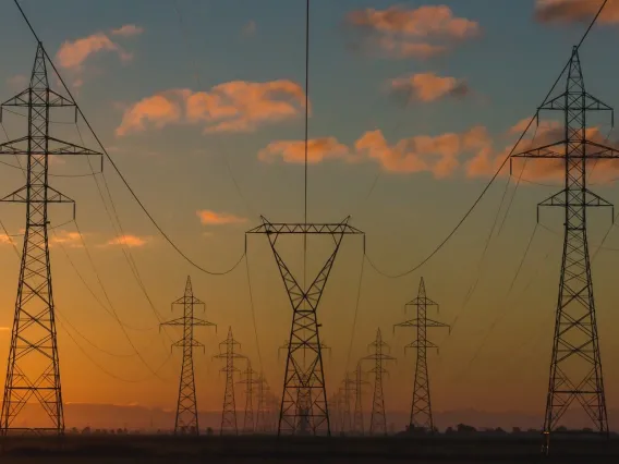 Energy grid with a setting sun in the background