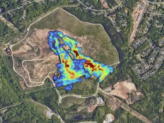 Methane plumes in neon colors stand out in an aerial view of a Georgia landfill surrounded by homes.