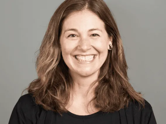 Carissa DiCindio, Woman smiling with brown hair against gray background.