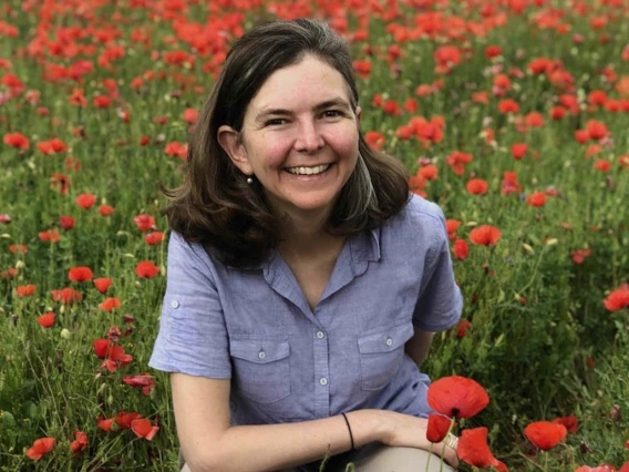 Gretchen Hendrson in field of poppies.