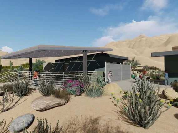 Shaded structures under a blue sky in the desert.