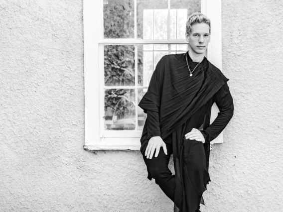 Portrait of Matthew Williams in front of a window