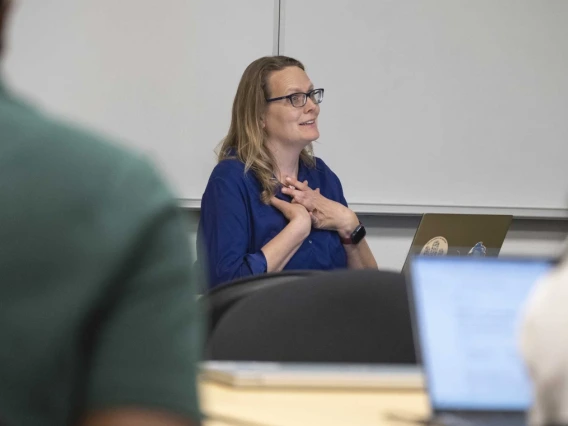 Kacey Ernst smiles while in a work meeting.