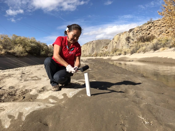 Woman doing research on riverbed 