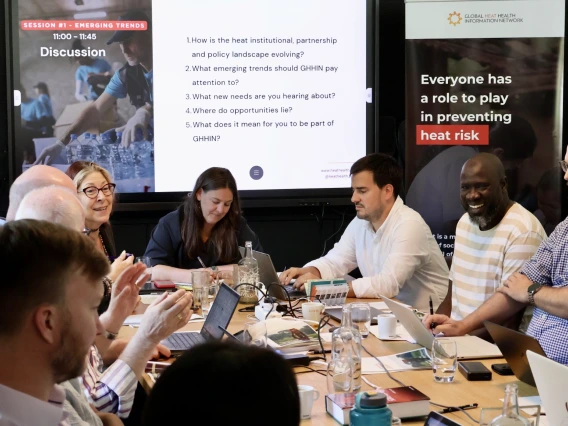 People gathered around a table working together.