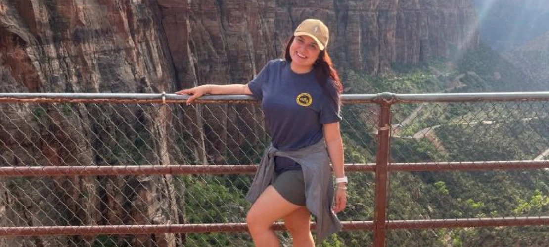 Gabriella Parra posing for a picture in front of the canyon at Zion national park.