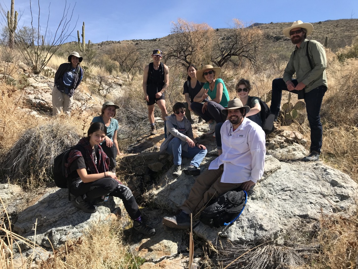 Earth Grant and UC3 students and Sky Islands Alliance staff pose by Rock Spring in Saguaro National Park East.