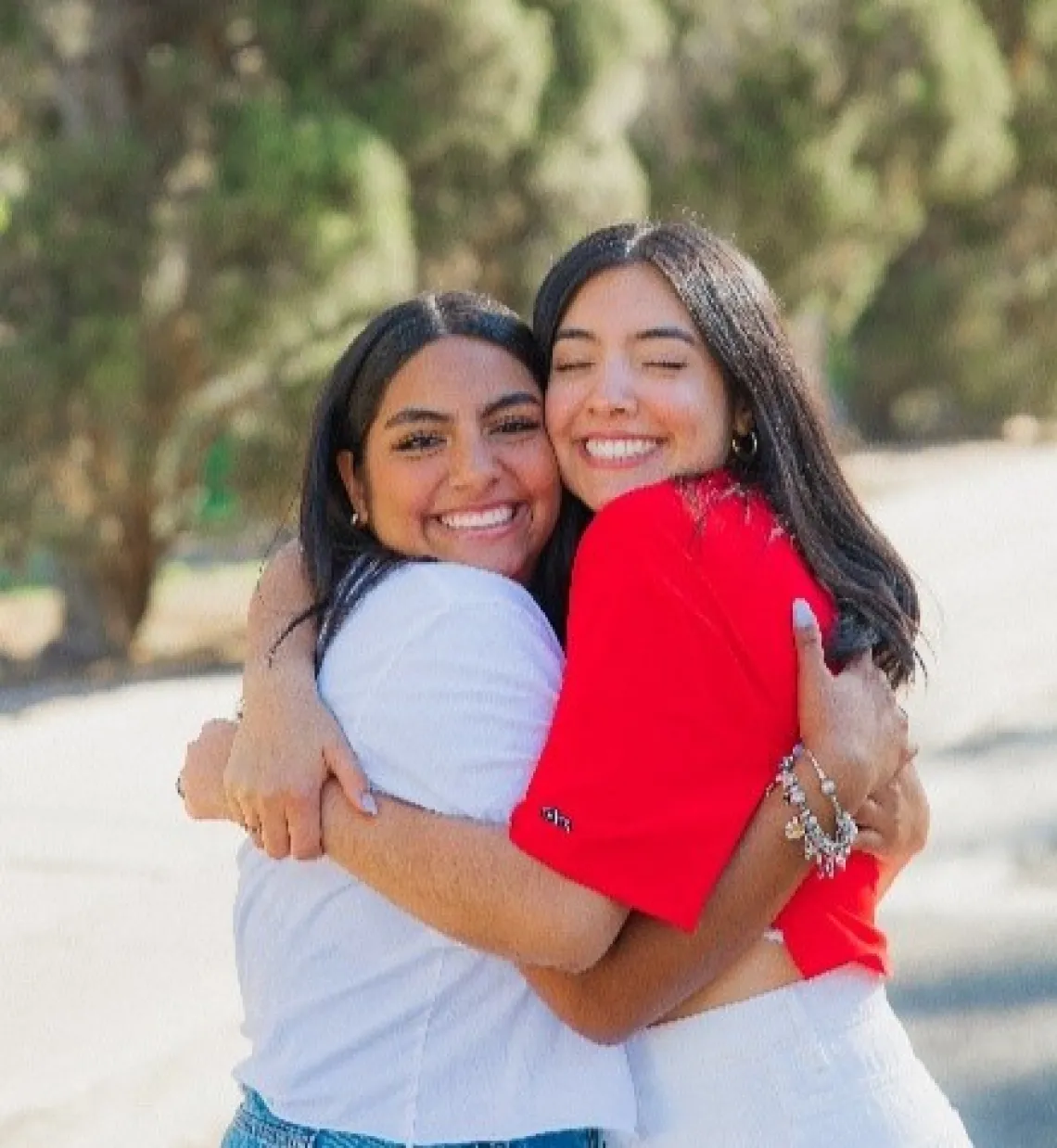 Two women smiling and hugging each other