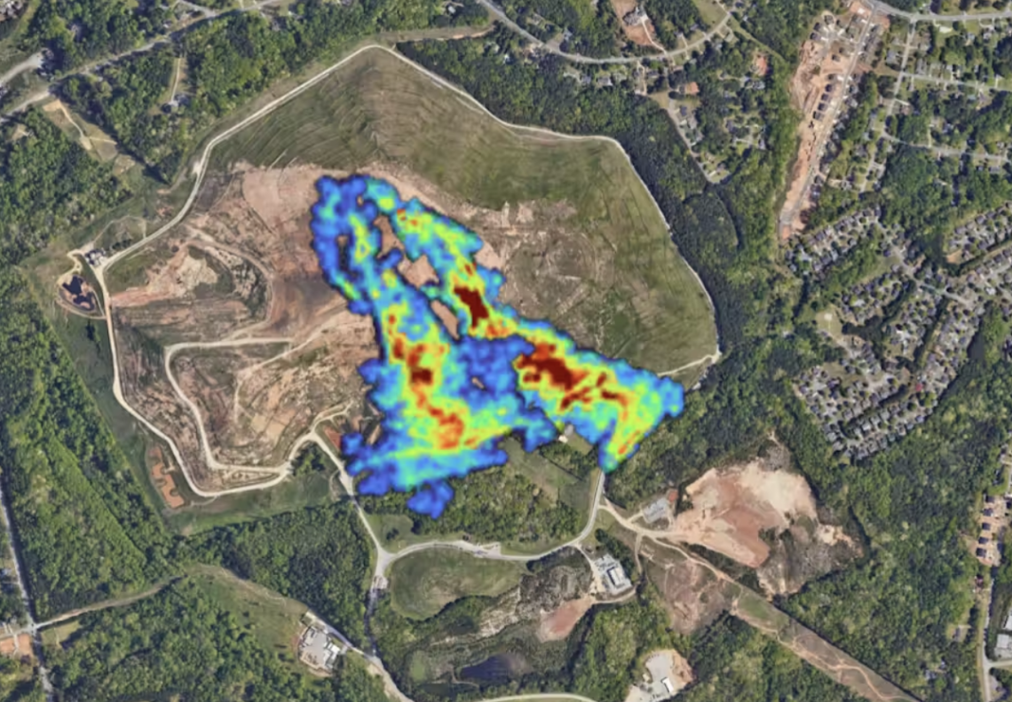 Methane plumes in neon colors stand out in an aerial view of a Georgia landfill surrounded by homes.