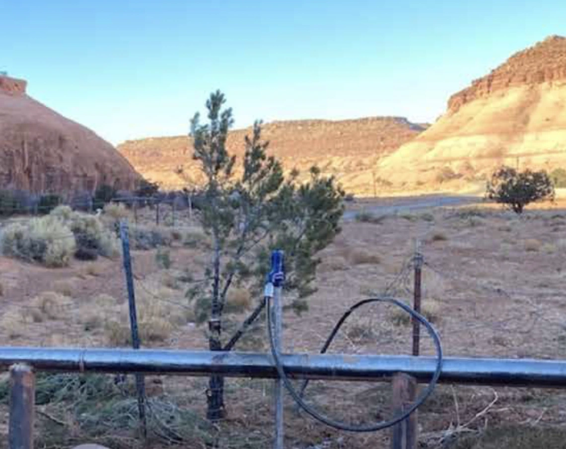 A water pump is shown with a desert canyon in the background.