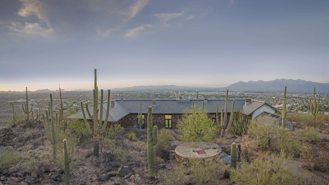 The Desert Laboratory surrounded by saguaro cacti with mountains against the skyline.