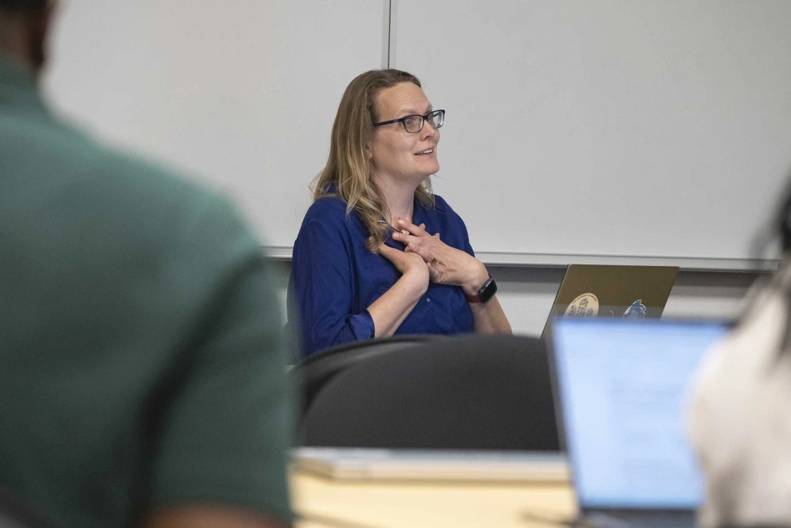 Kacey Ernst smiles while in a work meeting.