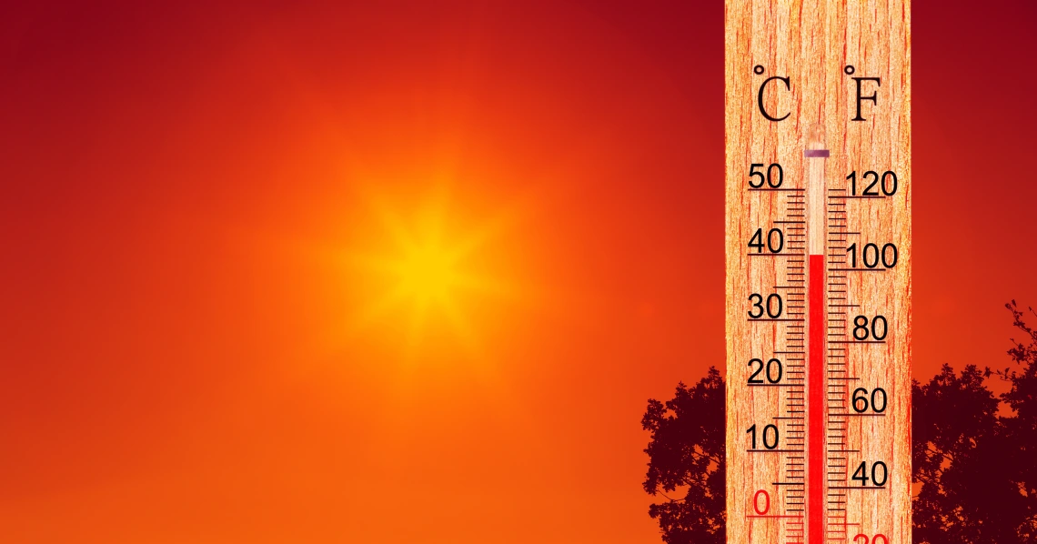 A hot sun in the background with a thermometer in the foreground.