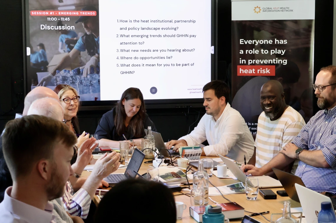 People gathered around a table working together.