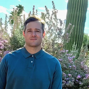 Student with blue shirt in desert scape 