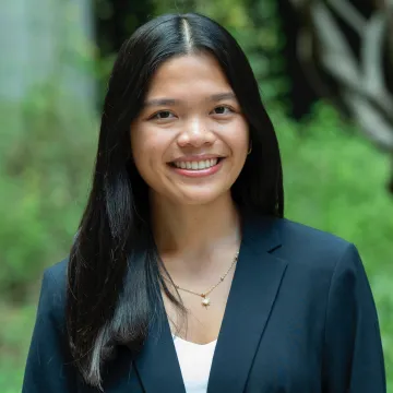 Student with dark hair smiling