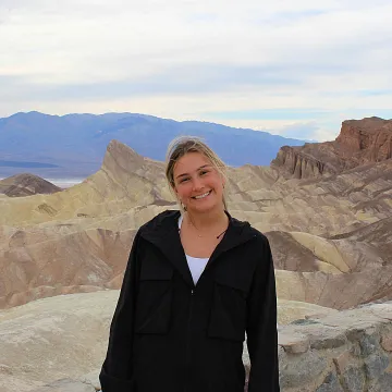 Student smiling with rock background