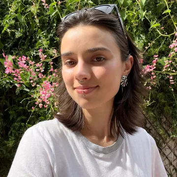 Student in front of flower wall