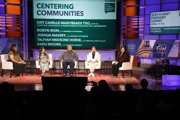 A panel presents on stage at the 2025 Planet Forward Summit.