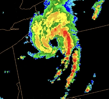 A radar view of a storm vortex on a dark background.