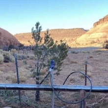 A water pump is shown with a desert canyon in the background.