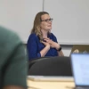 Kacey Ernst smiles while in a work meeting.