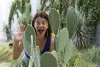 A headshot of Elise Gornish with a prickly pear cactus.